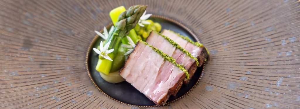 Smoked pork belly with lovage crumb and green peas